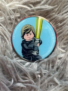 Lego Star Wars Minifigure Medallion with Yellow Lightsaber and Blue Background